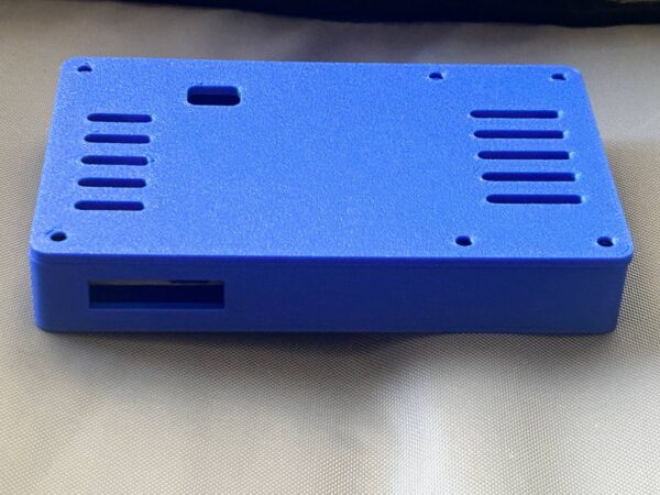 Physical blue ESP32 Power Pack Case with the lid closed and port window visible