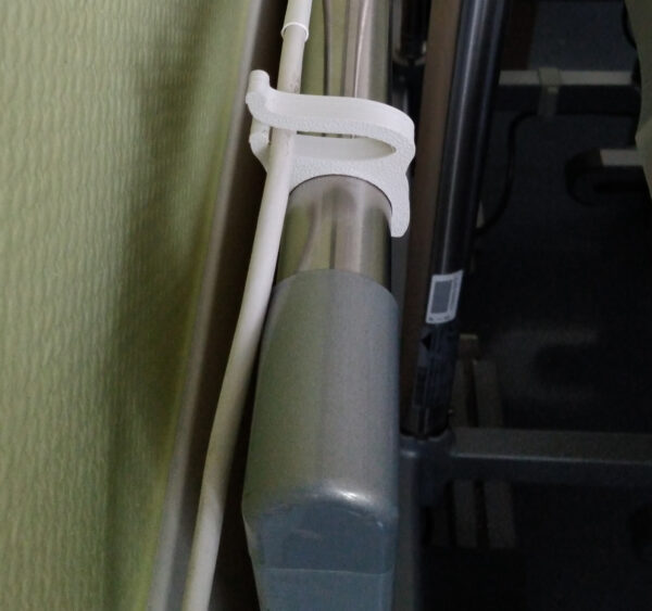 Physical 3D-printed cable guide clip installed on a round tube